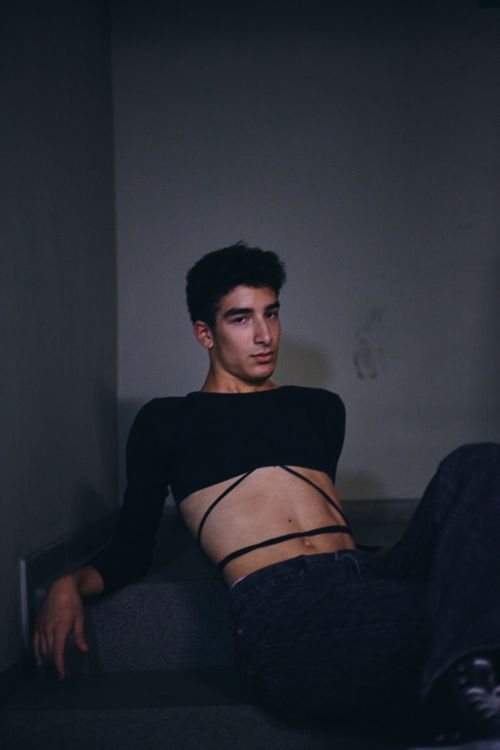Free Artistic portrait of a young man in modern fashion, captured indoors with a moody tone. Stock Photo