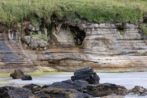 Free Stunning coastal rock formation in Scotland showcasing unique geological features and lush greenery. Stock Photo