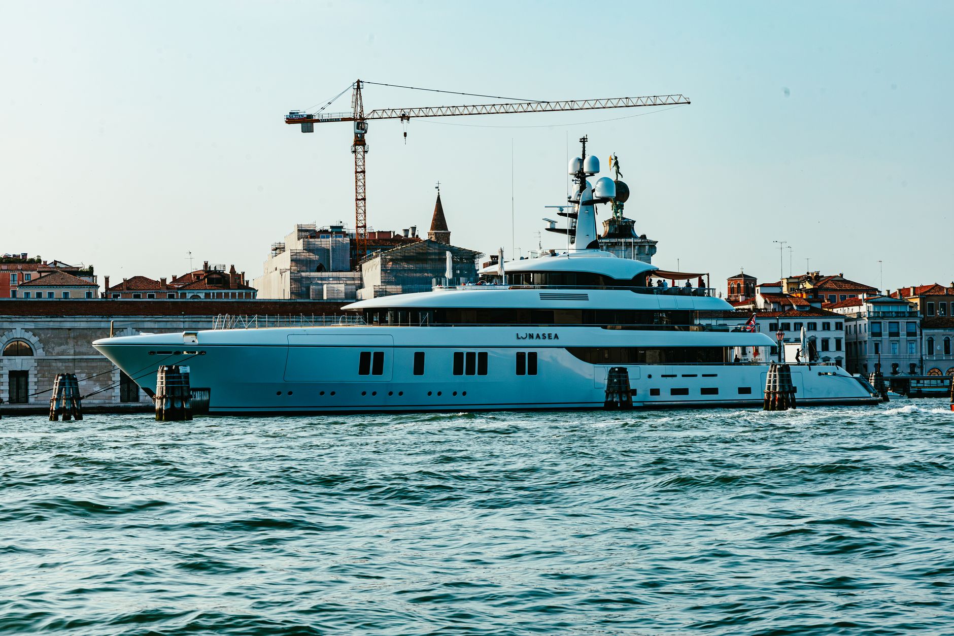 A luxury yacht moored in Venice, showcasing the city's iconic architecture and vibrant waterfront.