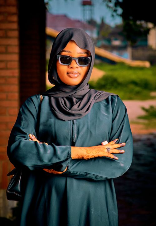 Free Elegant woman wearing hijab and sunglasses poses confidently outdoors. Radiating confidence and style. Stock Photo