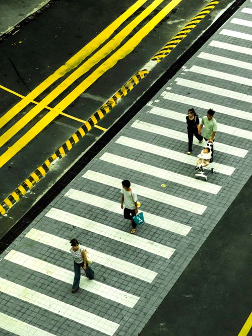 Free Diverse group crossing a city street on a zebra crossing from above. Stock Photo