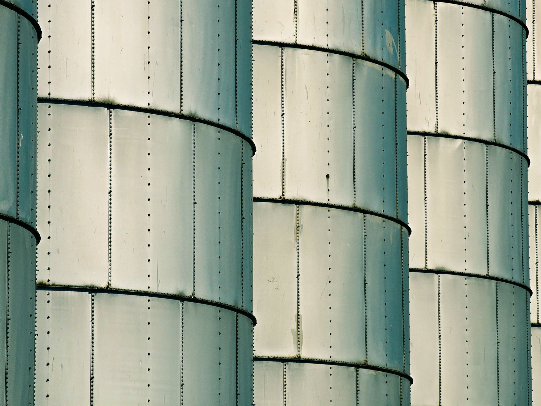 Detailed view of metal silos showcasing industrial architecture and pattern repetition.