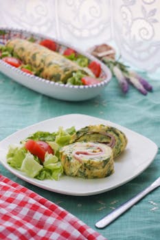 Tasty herb roll filled with ham, served with fresh lettuce and tomato salad.