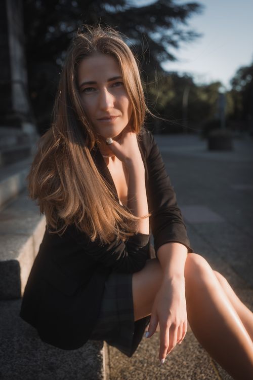 Woman in Black Dress on Concrete Stairs · Free Stock Photo