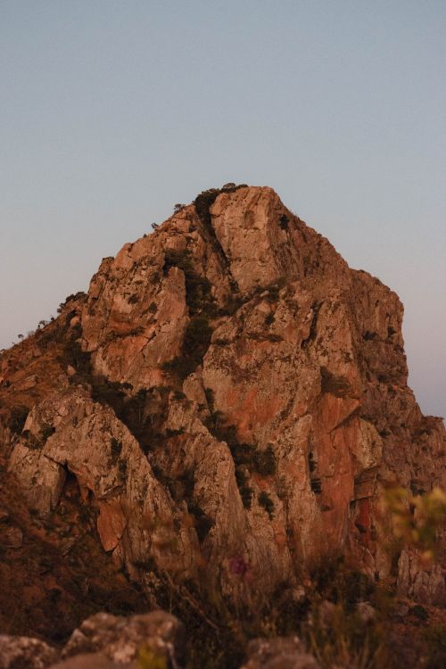 Free A striking image of a rocky mountain peak at twilight, showcasing natural rugged beauty. Stock Photo