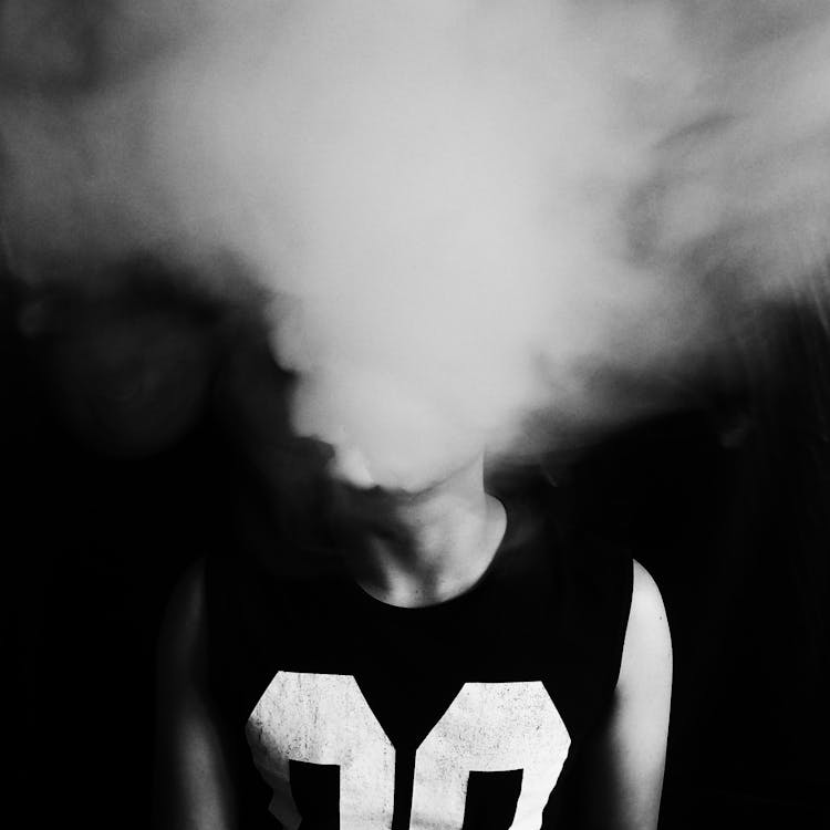 Close-up of Person Emitting Smoke