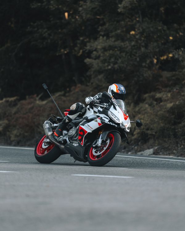 Dynamic Motorcycle Racer Taking a Sharp Turn Outdoors · Free Stock Photo