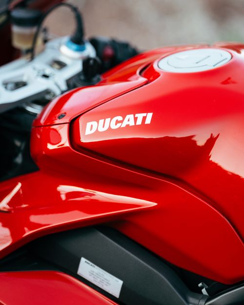 Free Vivid red Ducati motorcycle fuel tank close-up, sleek design. Stock Photo