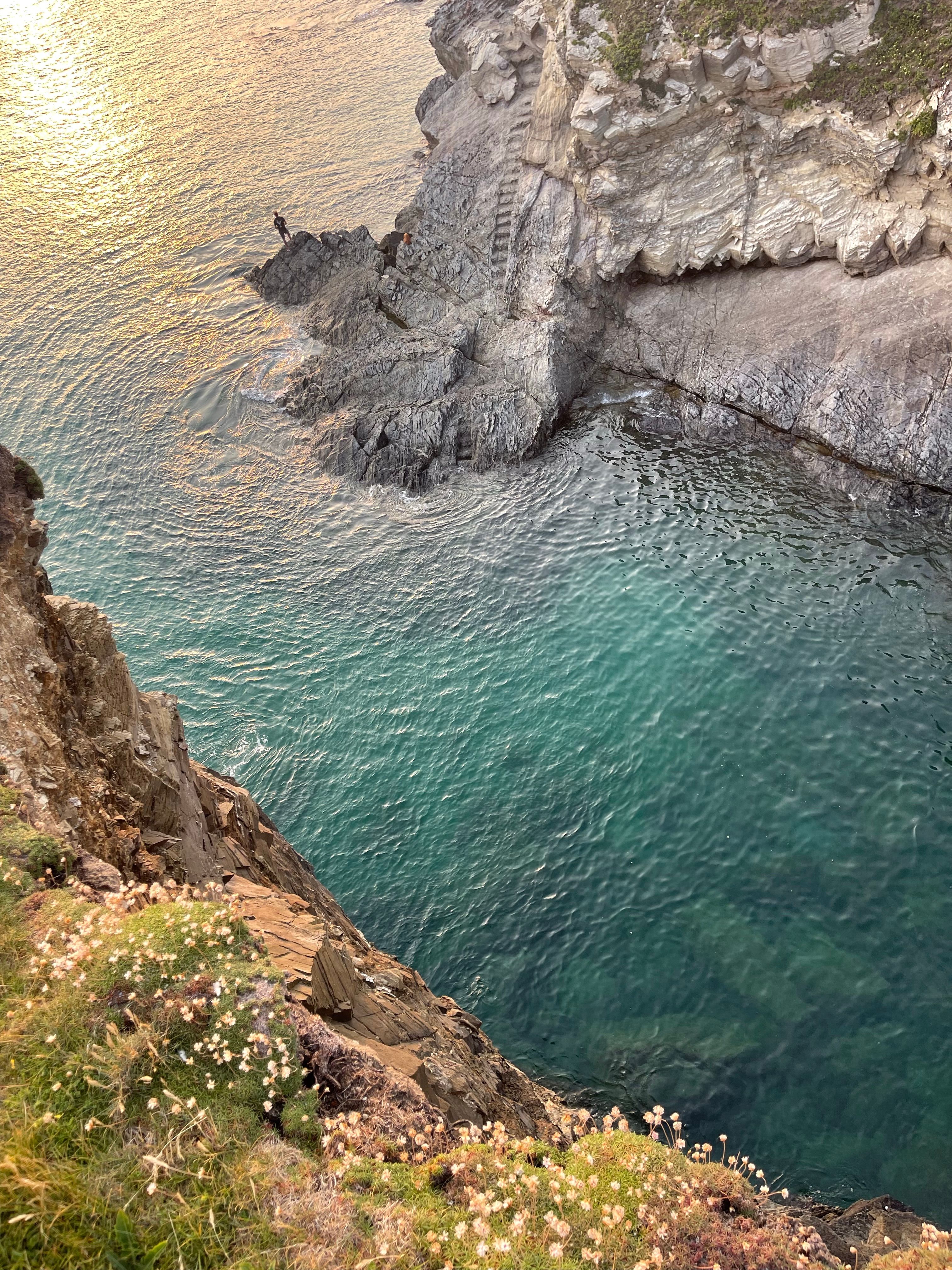 A stunning view of cliffs and crystal-clear waters in England's coastal area.