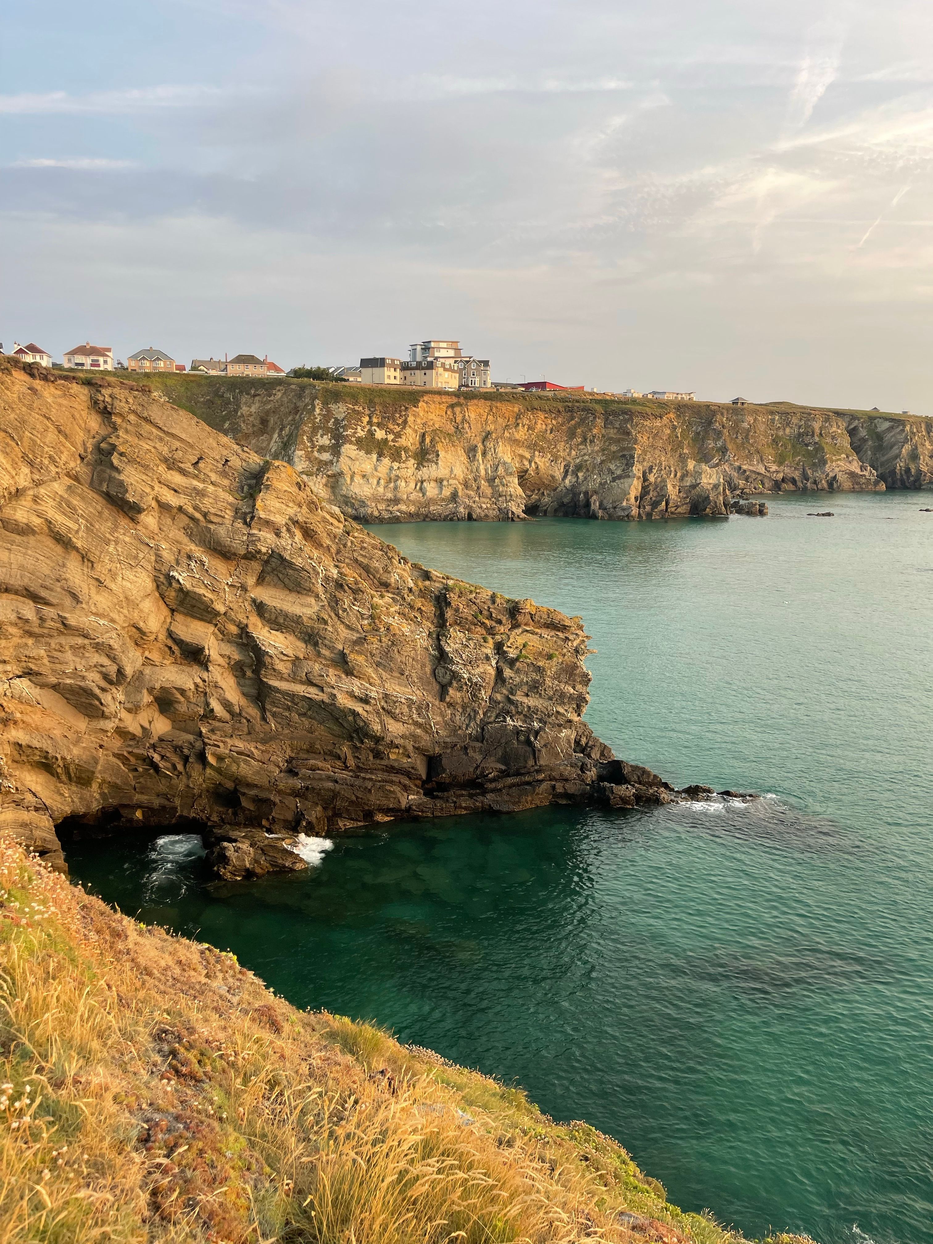 Newquay's rugged coastline at sunset, England