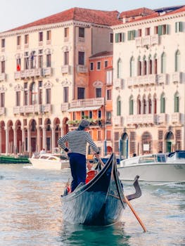 Charming gondola ride on Venice's Grand Canal with historic architecture backdrop.