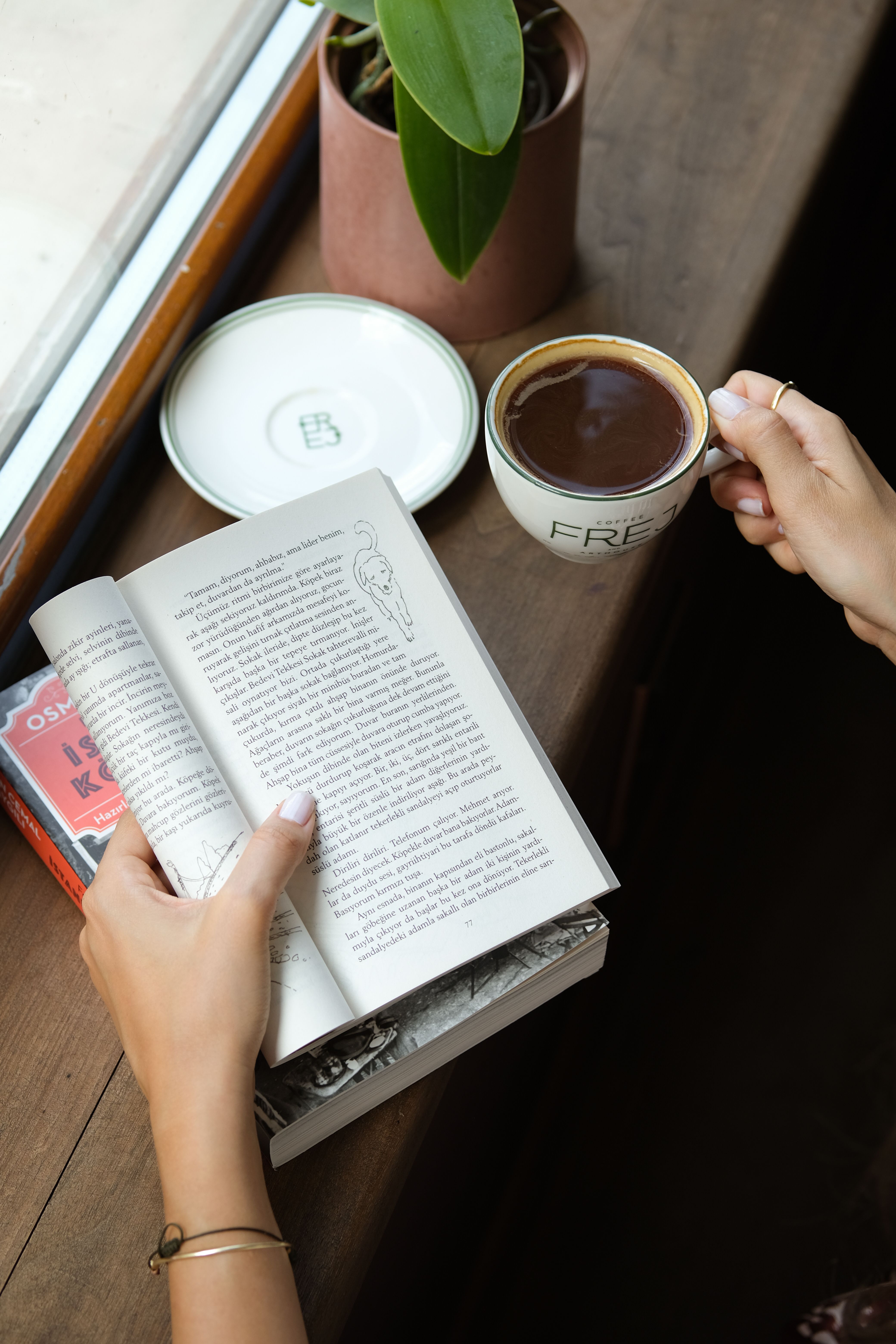 Relaxing moment with a book and coffee by the window in İstanbul.