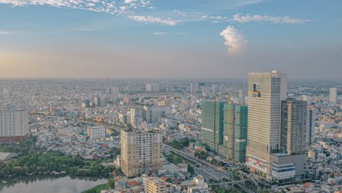 Free Aerial view of a bustling cityscape with modern skyscrapers and clear sky. Stock Photo