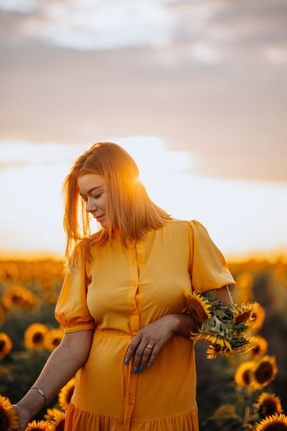 Woman in a sunflower field at sunset — photo by Galina Kolonitskaia on Pexels