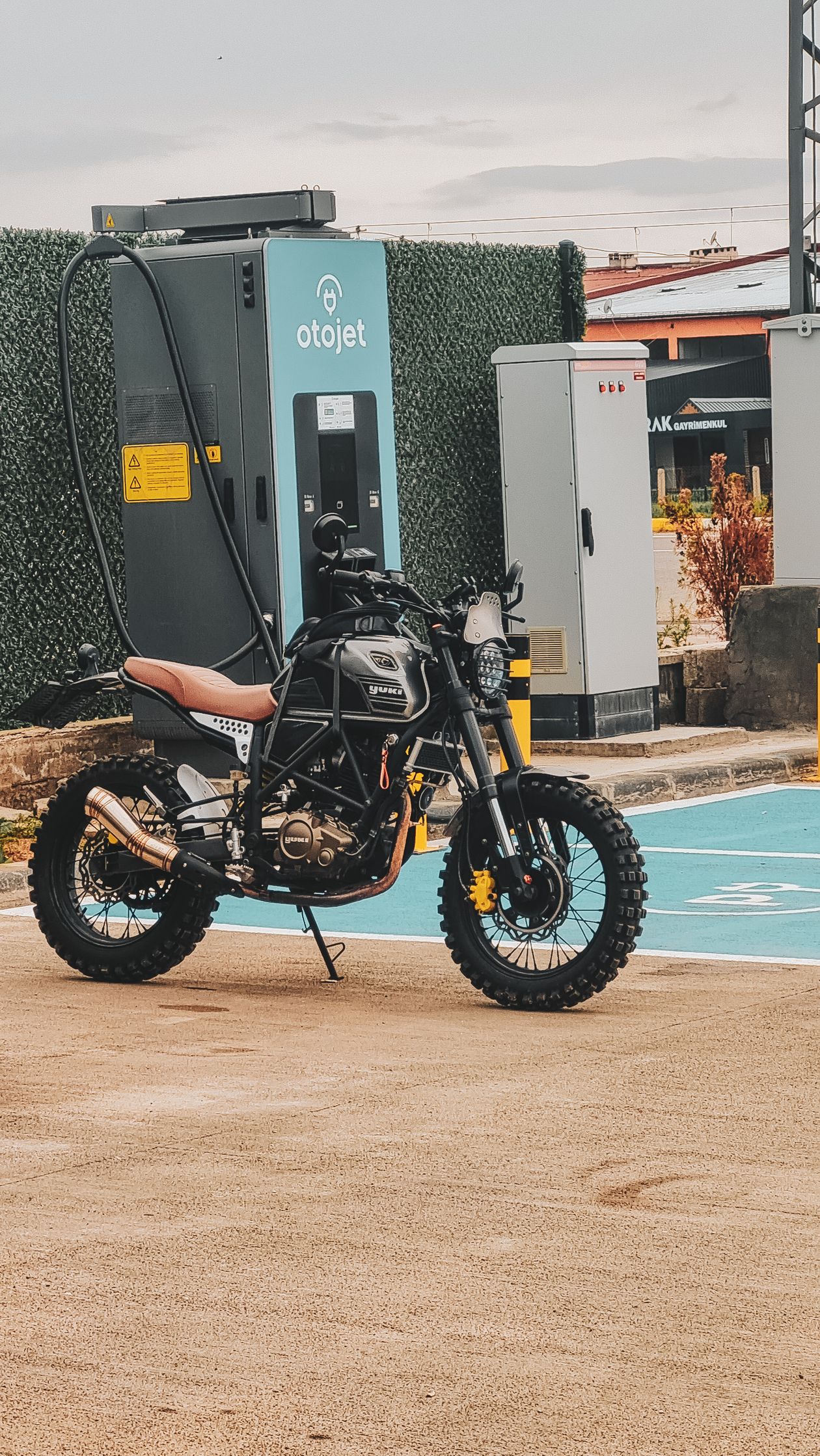Electric motorcycle parked at an EV charging station