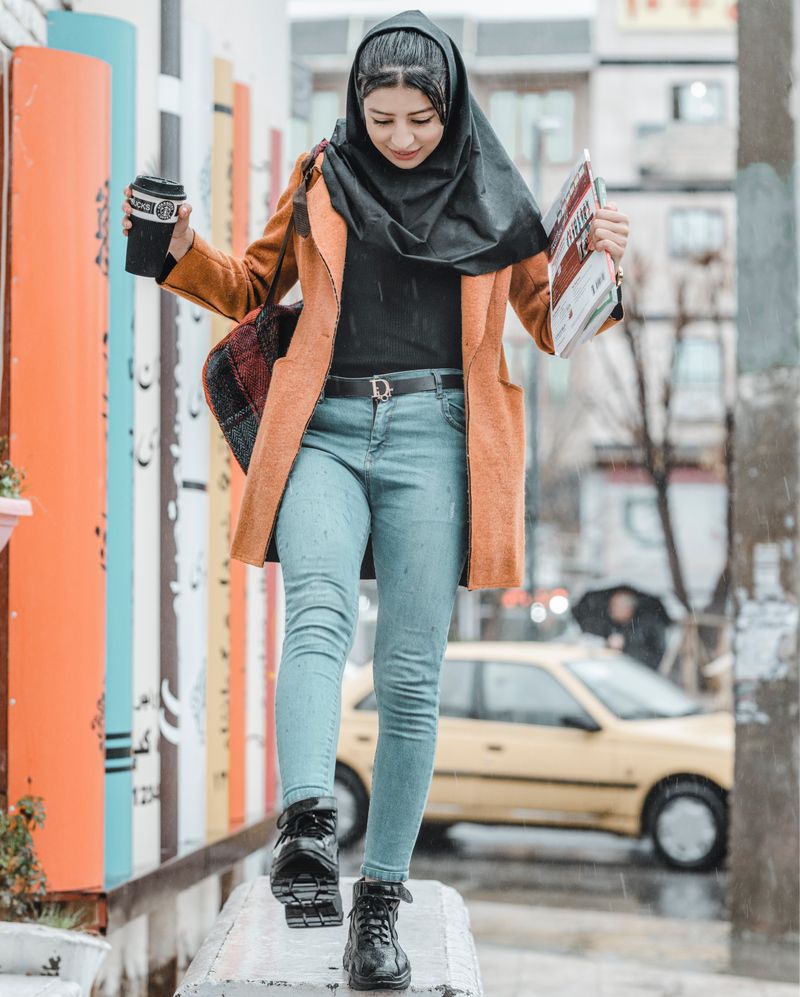 Woman in brown coat and jeans