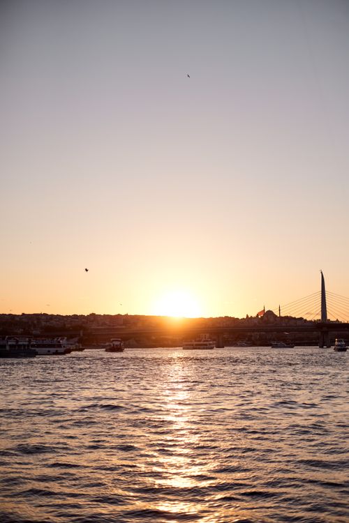 Free A serene sunset over the Bosphorus in Istanbul, capturing the beauty of the city's silhouette and bridge. Stock Photo