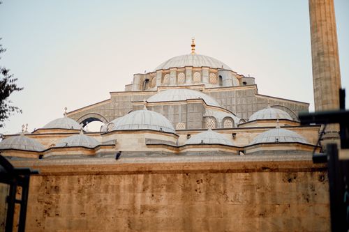 Free A stunning view of a mosque in İstanbul at sunset with intricate domes and a calm ambiance. Stock Photo