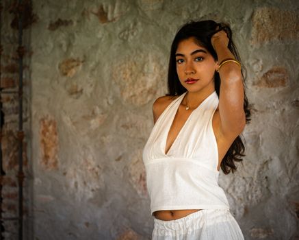 Elegant portrait of a woman in a white dress, captured indoors in Querétaro, Mexico.
