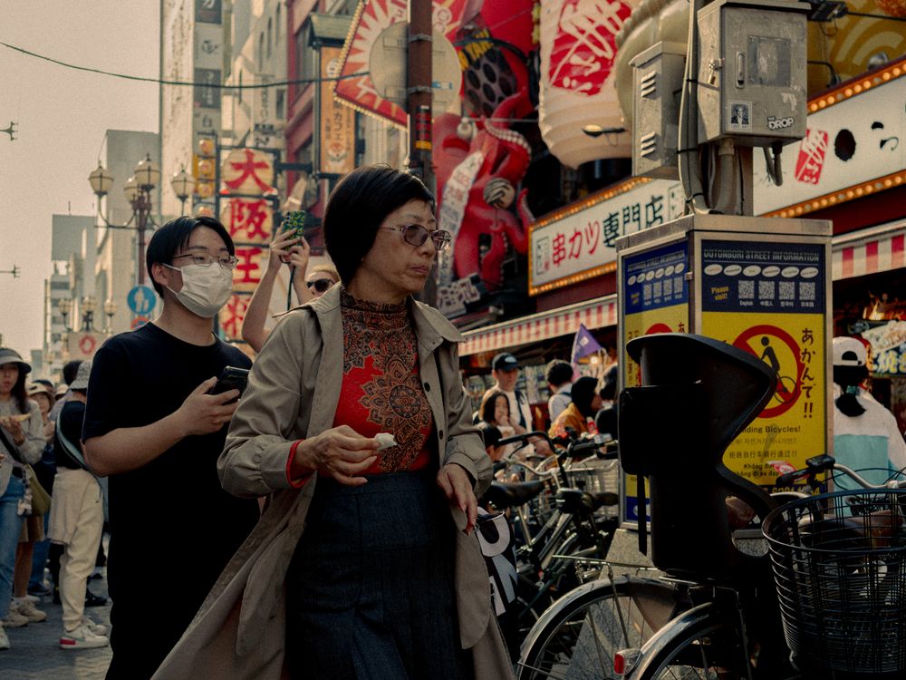 People enjoying the streets of Osaka, Japan — the everyday life that international buyers are actually buying into