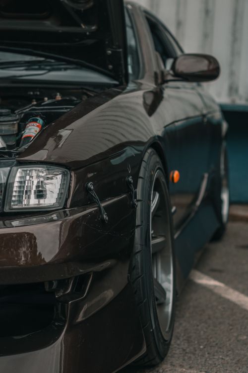 Free Detailed view of a vintage sports car's front end, showcasing its sleek design and powerful presence. Stock Photo
