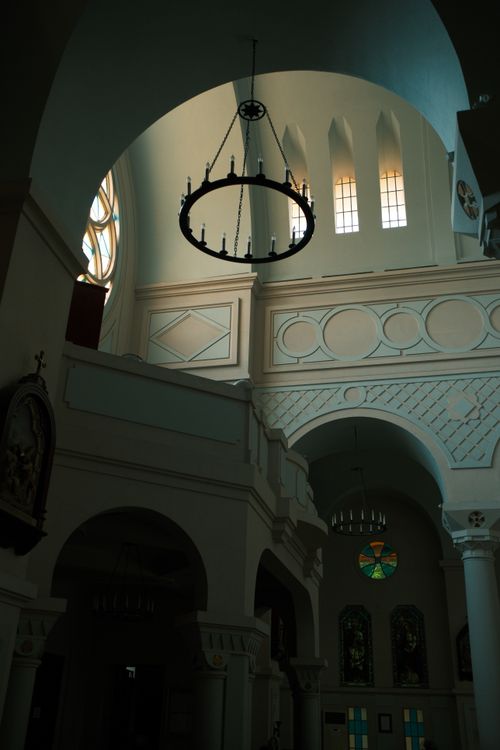 Free Beautiful interior of a church with arched ceilings and stained glass windows. Stock Photo