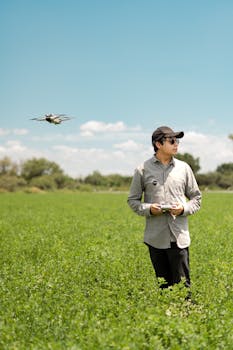 Man operating a drone in a lush field, capturing the beauty of nature in Santiago de Querétaro, Mexico.