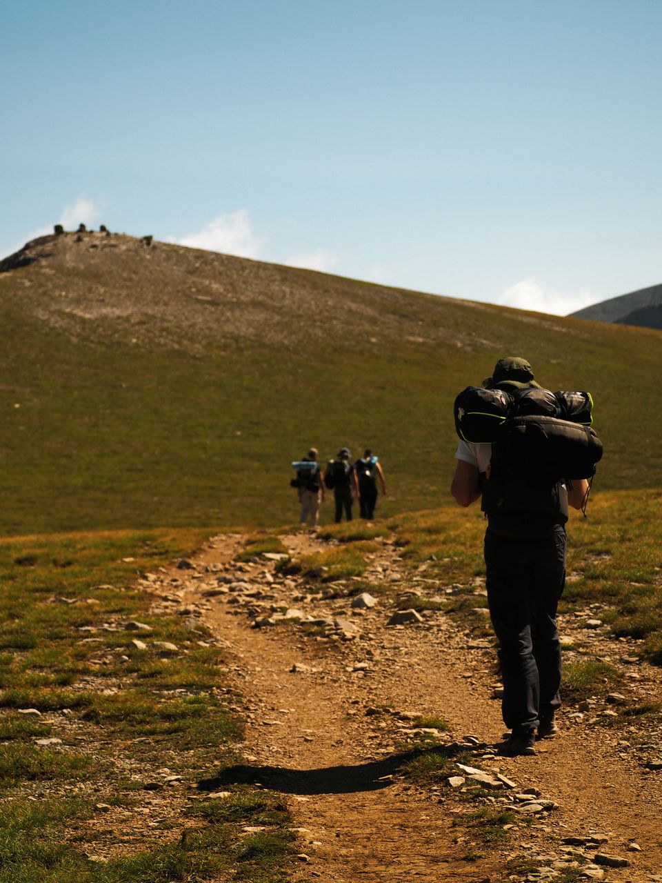Hiker with a backpack on a mountain trail