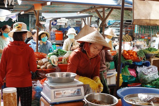 Explore the bustling life of a Vietnamese street market in Ho Chi Minh City, capturing vendors and vibrant produce.
