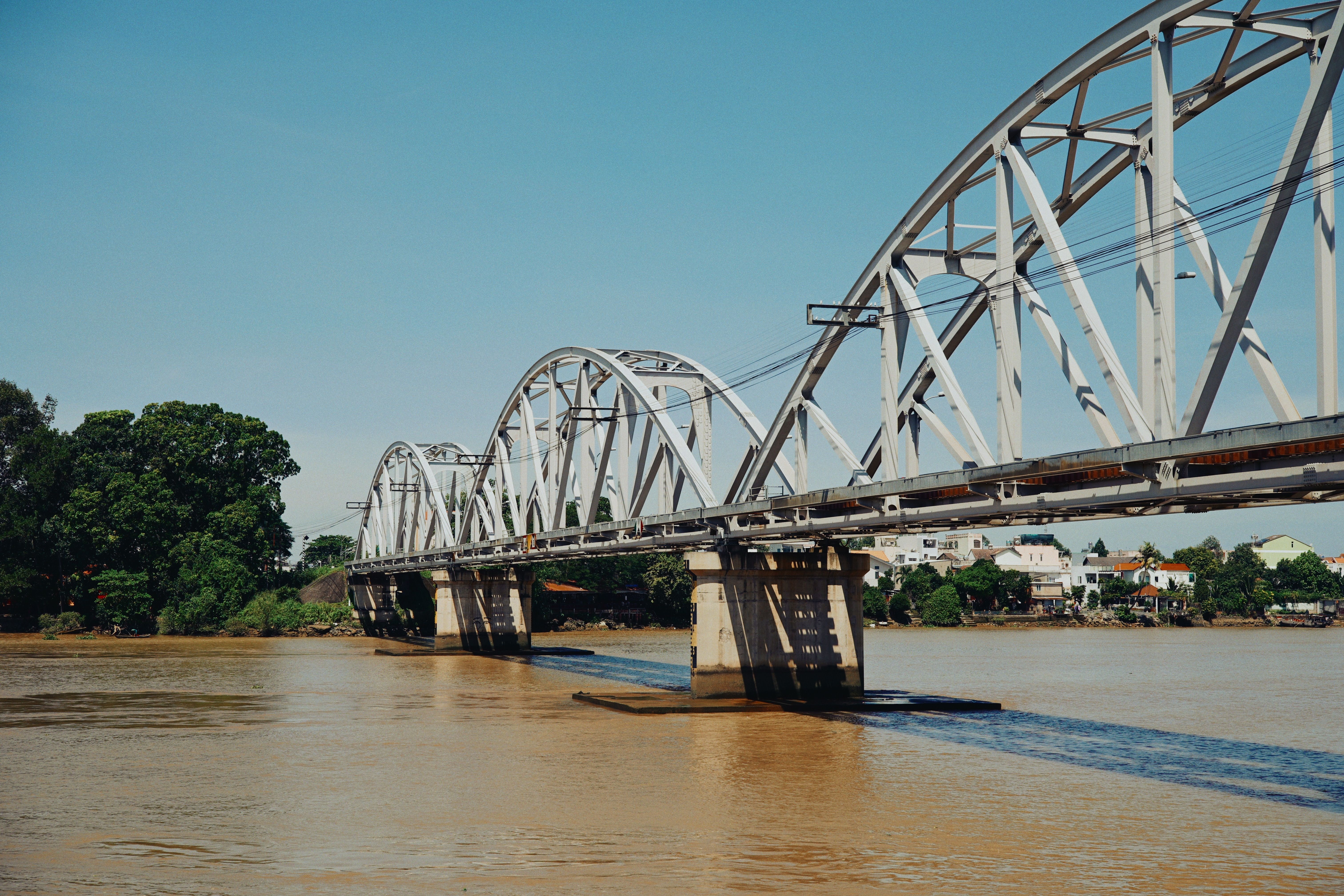 Steel Arch Bridge Over Calm River in Sunny Day · Free Stock Photo