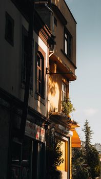 A peaceful urban street with sunlit building facades exuding a warm, inviting ambience.
