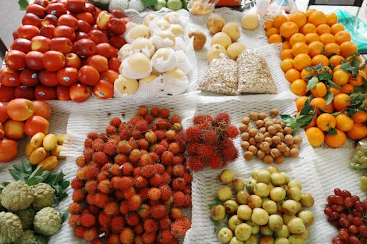 A colorful display of tropical fruits at a market stall in Ho Chi Minh City, Vietnam.
