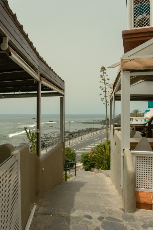 Free A picturesque view from Valle Gran Rey, Canary Islands, overlooking the Atlantic Ocean and coastal promenade. Stock Photo
