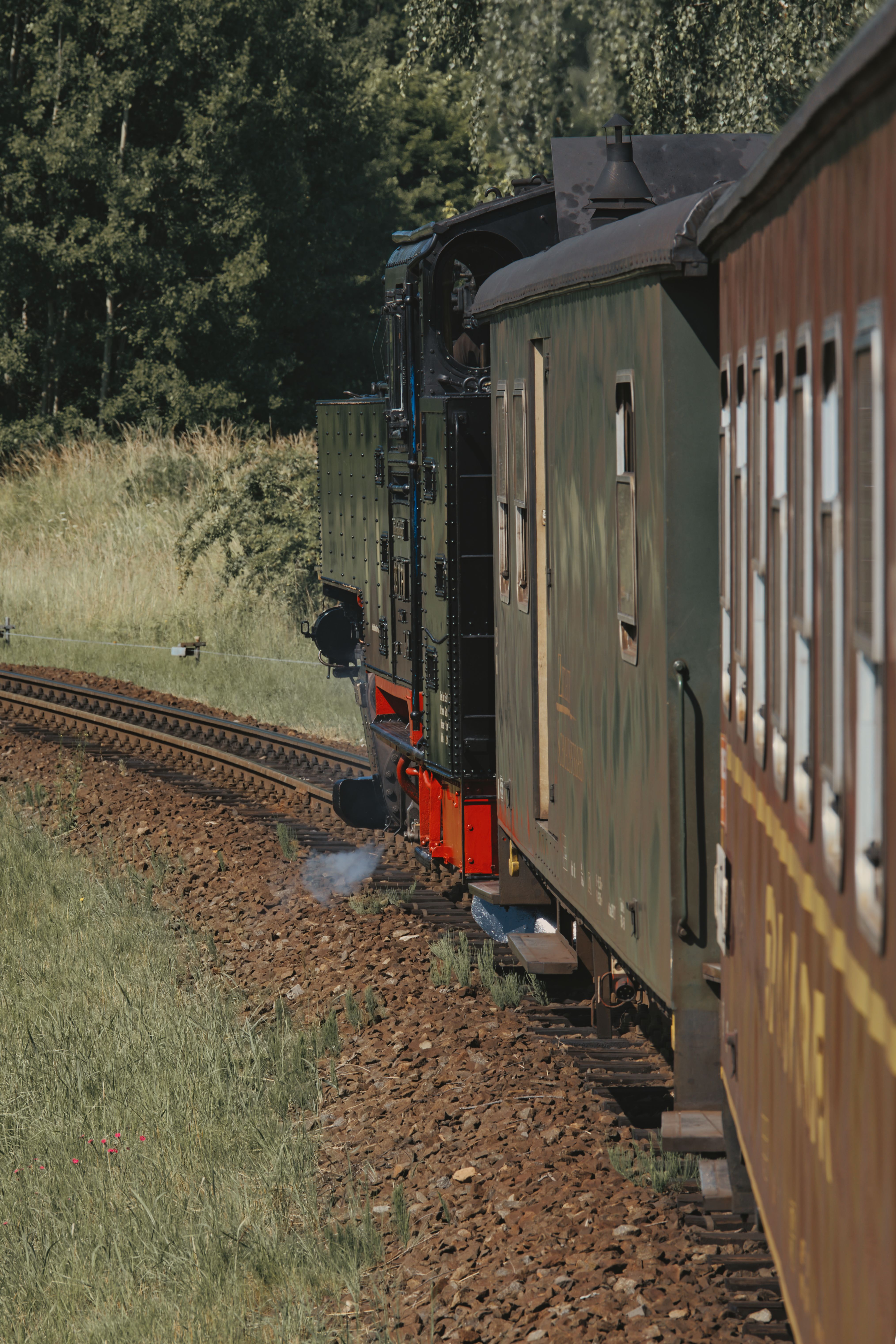 Vintage steam train journey through lush nature near Zittau, Saxony, Germany.