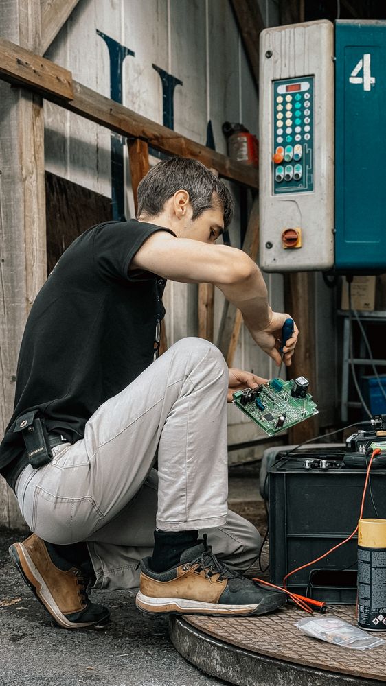 Electrical technician working on control panel