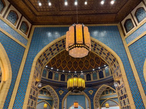 Free A stunning interior showcasing Islamic architecture with detailed tile work and traditional lanterns. Stock Photo
