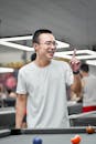 Happy Man Playing Billiards Indoors in Hanoi