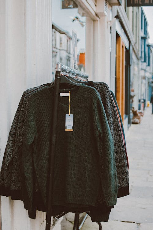 Assorted Clothes Hanging On A Rack Outside Store