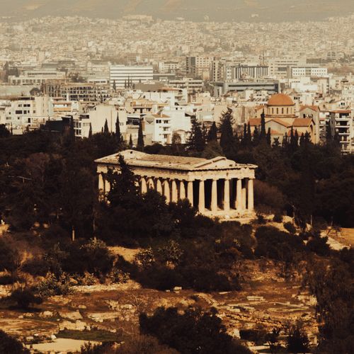 Free Aerial view of Hephaestus Temple in Athens, blending ancient architecture with urban skyline. Stock Photo