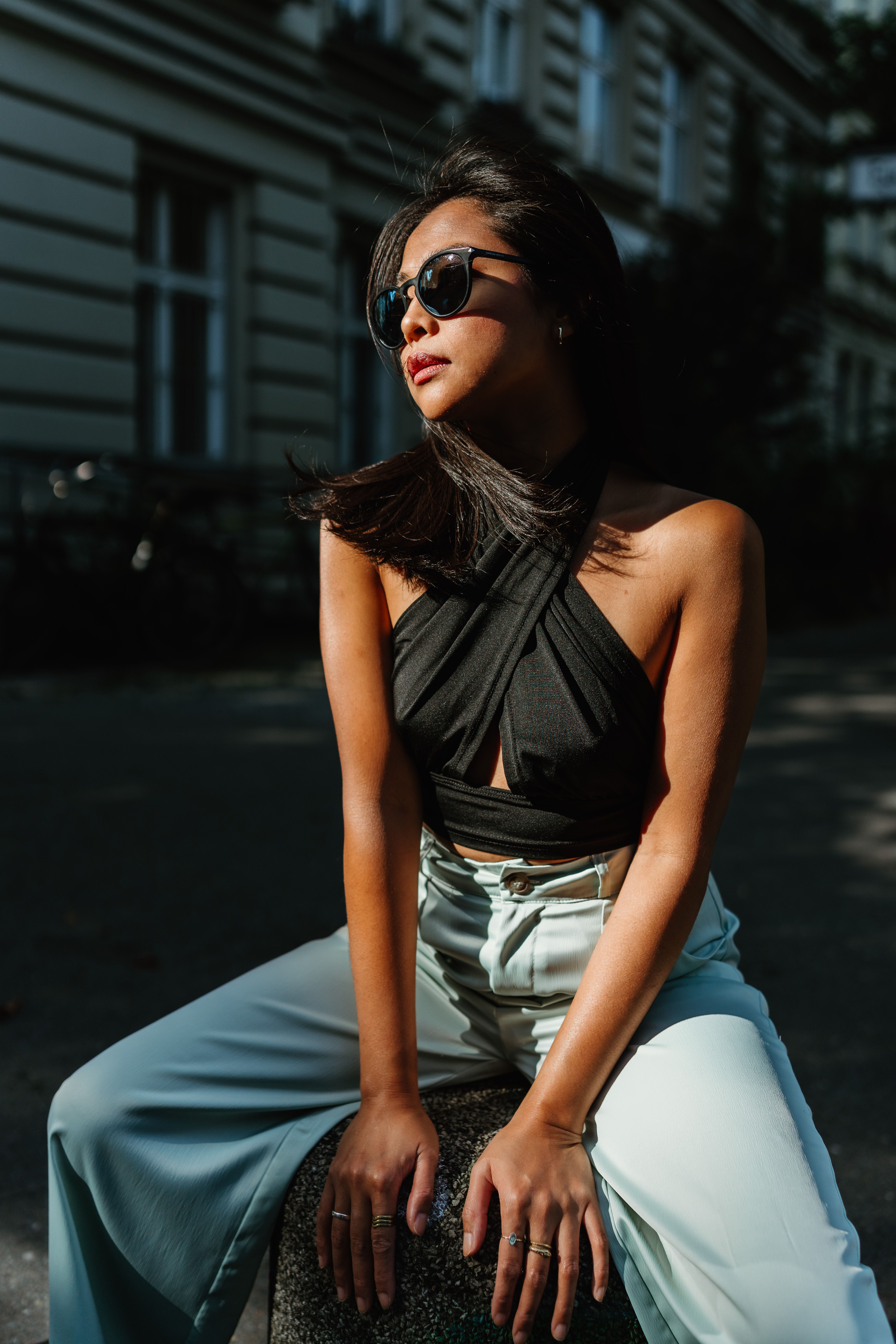 Outdoor portrait of a fashionable woman posing in Berlin with natural light highlighting her features.