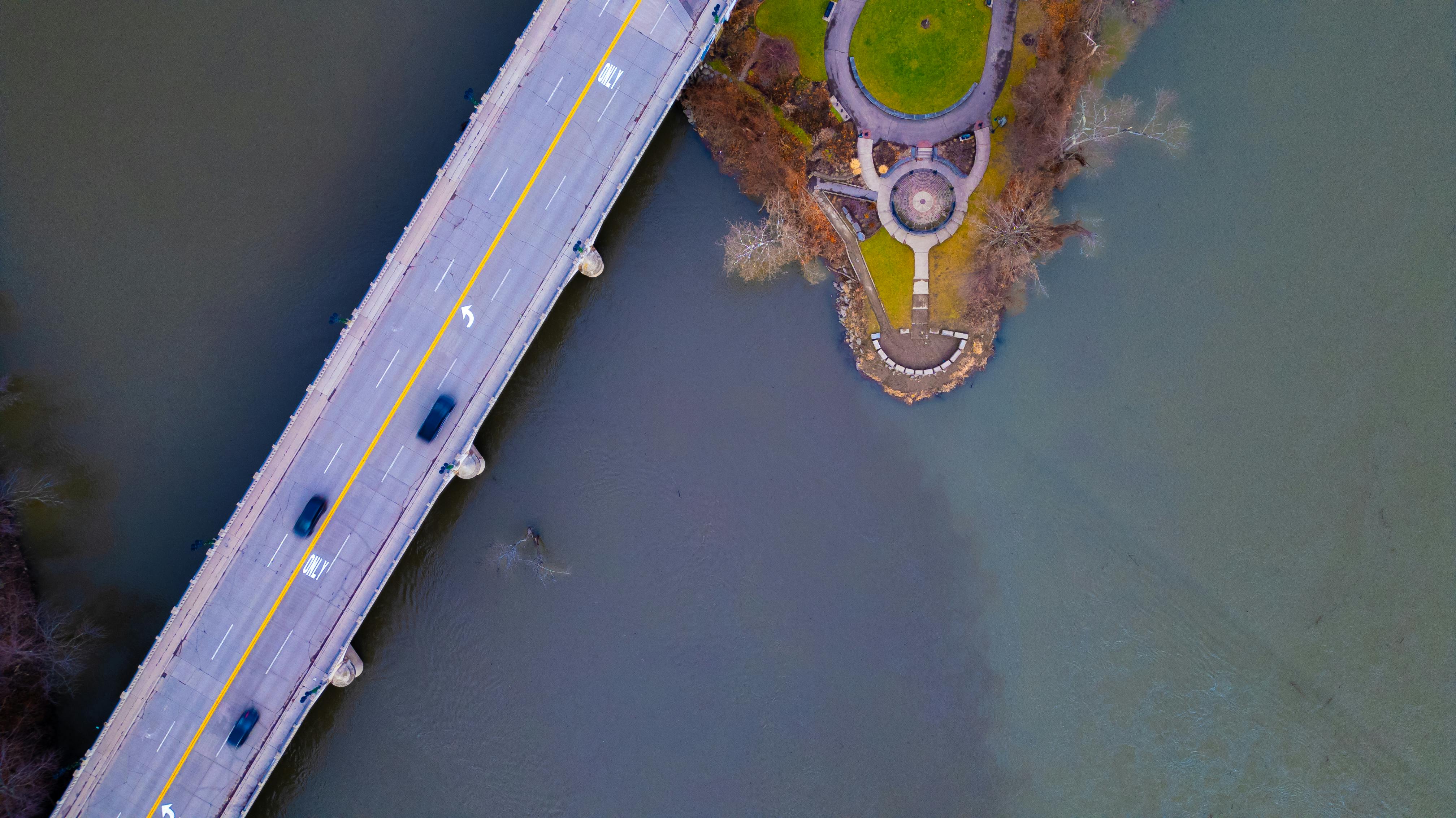 Aerial view of a bridge crossing a river with adjacent park in Binghamton, New York.