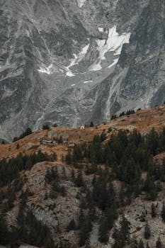 Explore the serene beauty of Valle d'Aosta's rugged mountains and charming alpine village.