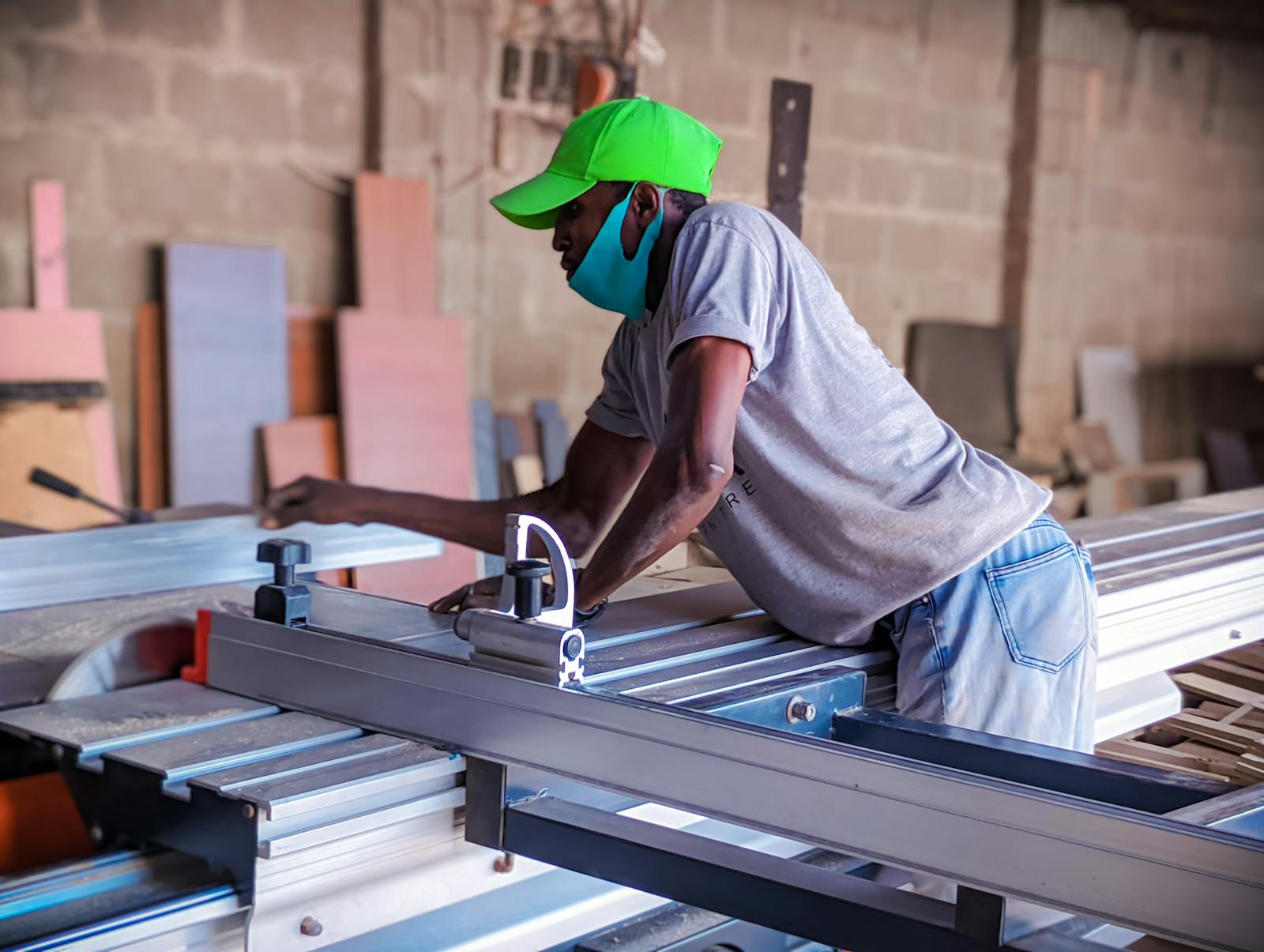 Nigerian manufacturing technician operating machinery in a production workspace