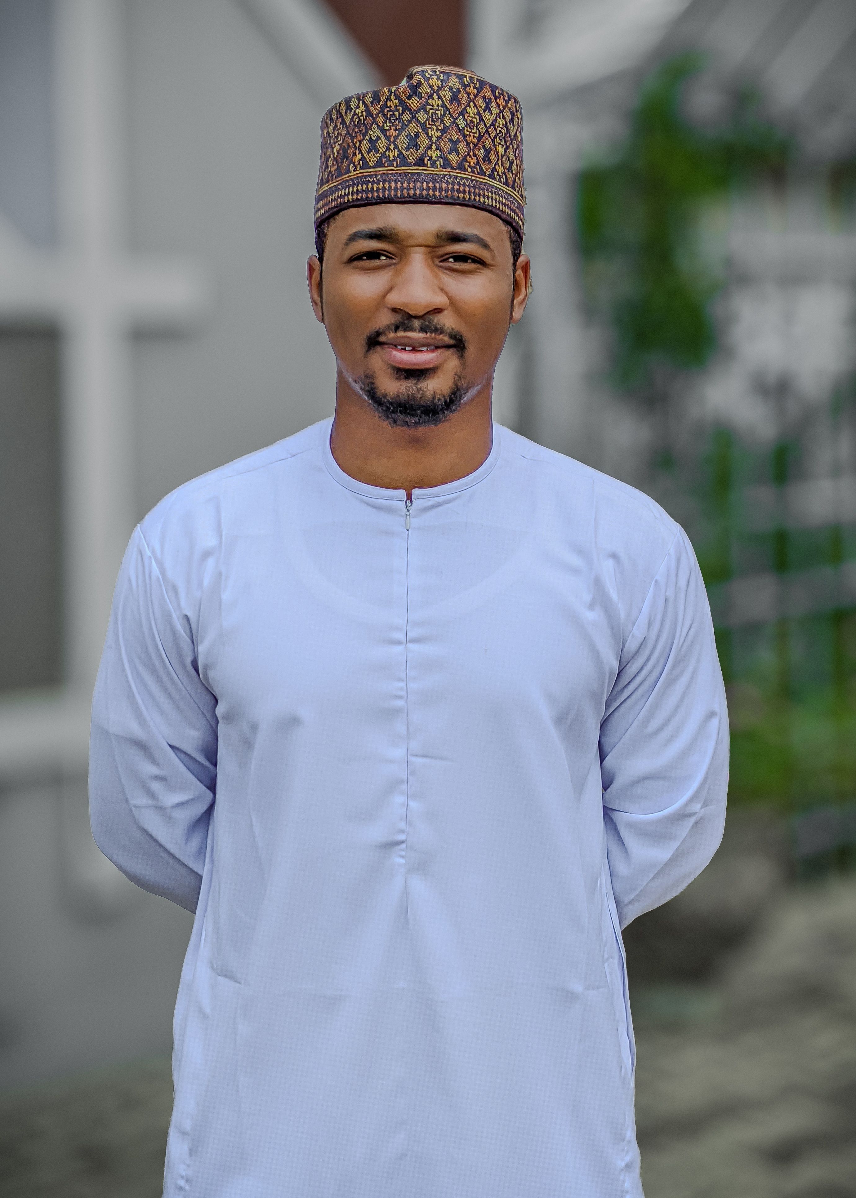Outdoor portrait of an adult man wearing traditional Nigerian attire in Kaduna.