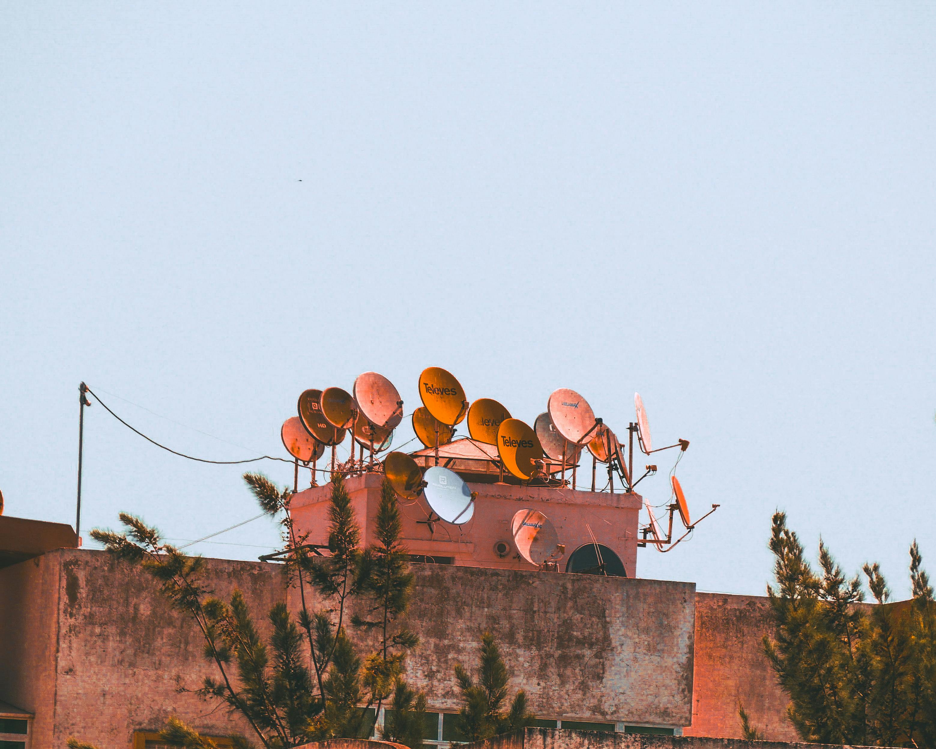 A view of various satellite dishes atop a rooftop in Tanger, Morocco.