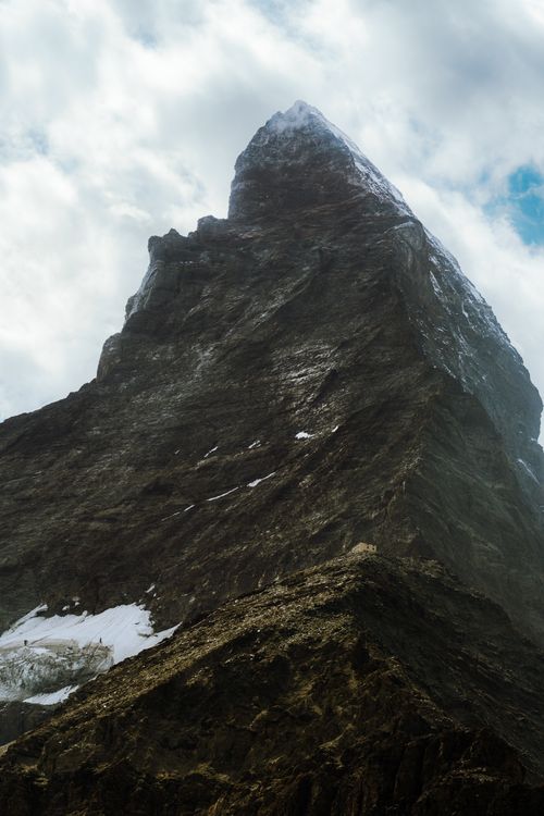 Free Stunning view of the iconic Matterhorn peak in Zermatt, captured under a cloudy sky. Stock Photo