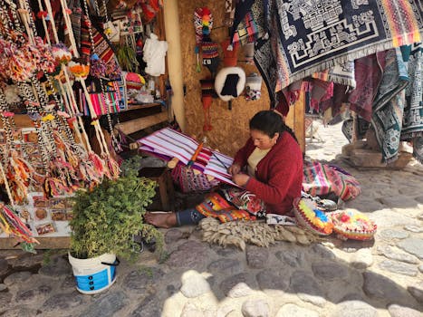 Artisan woman weaving traditional textiles in a vibrant Peruvian market.