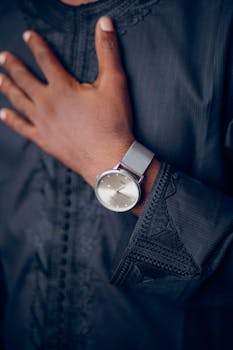 Close-up of a person in traditional African attire wearing an elegant wristwatch.