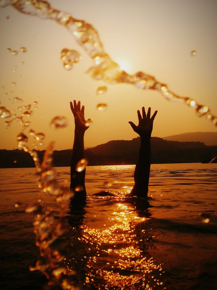 Hands Above Water