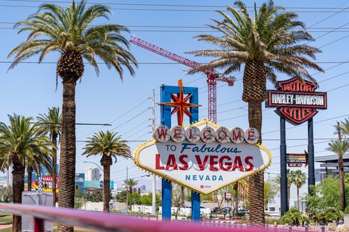 Free Famous Welcome to Las Vegas sign with palm trees and bright skies, capturing the essence of Nevada's charm. Stock Photo